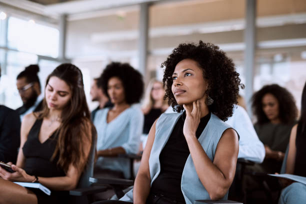 Shot of a businesswoman listening intently during a conference